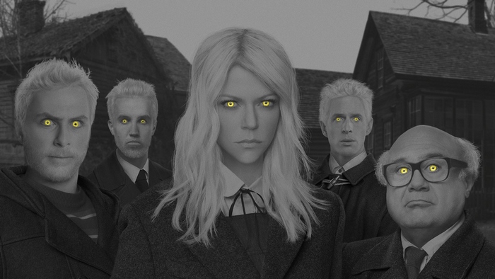 Group with glowing yellow eyes in front of a house