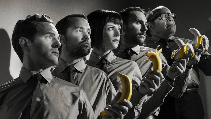 Group of people holding bananas