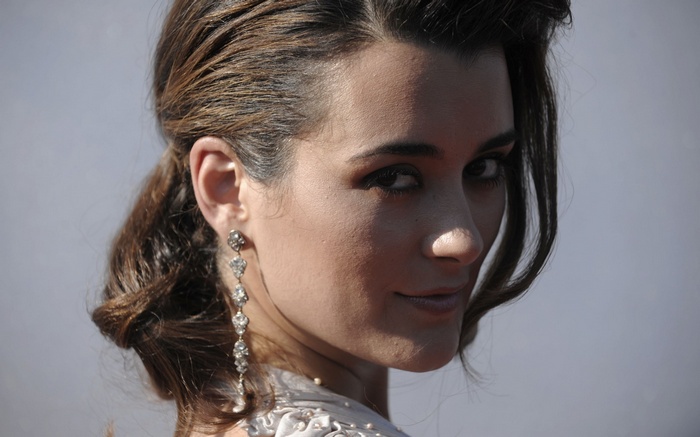 Woman with long earrings and styled hair