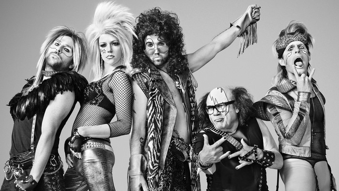 Five people in rockstar costumes