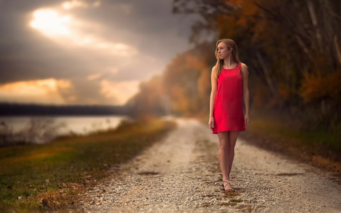 Woman in red dress walking on a path