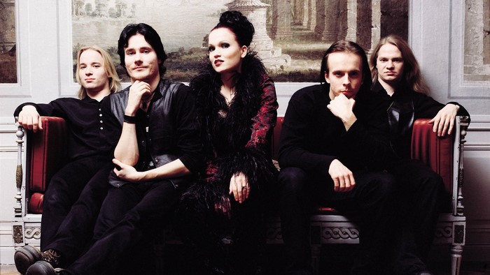 Nightwish band members posing on a couch
