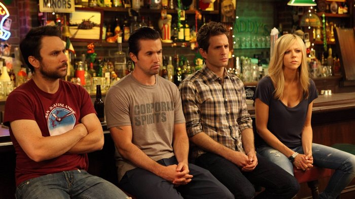 Four people sitting at a bar