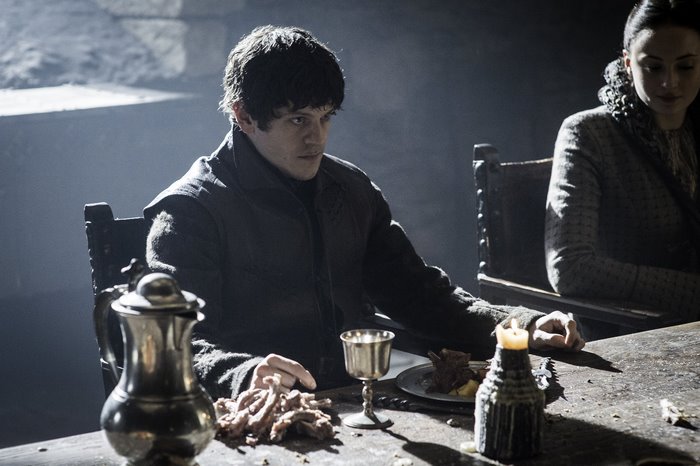 Iwan Rheon at a table