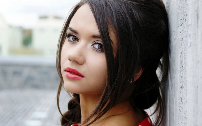 Young woman with dark hair and red lipstick