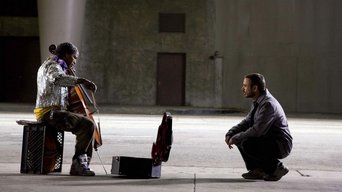 Jamie Foxx playing cello for a man