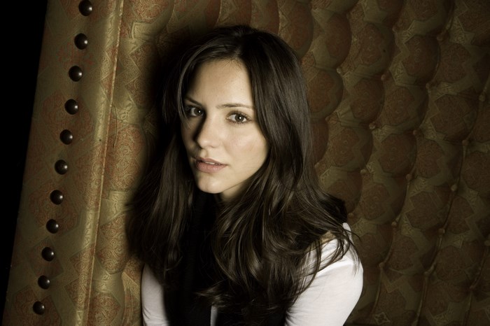 Katharine McPhee sitting on a tufted chair