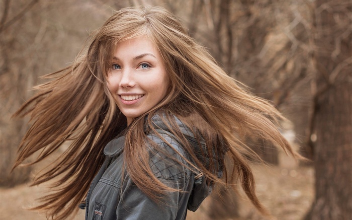 Young woman with long brown hair outdoors