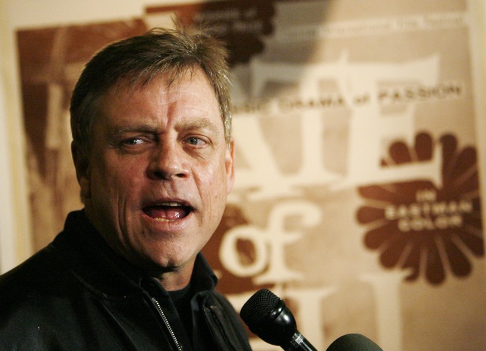 Mark Hamill speaking into microphones