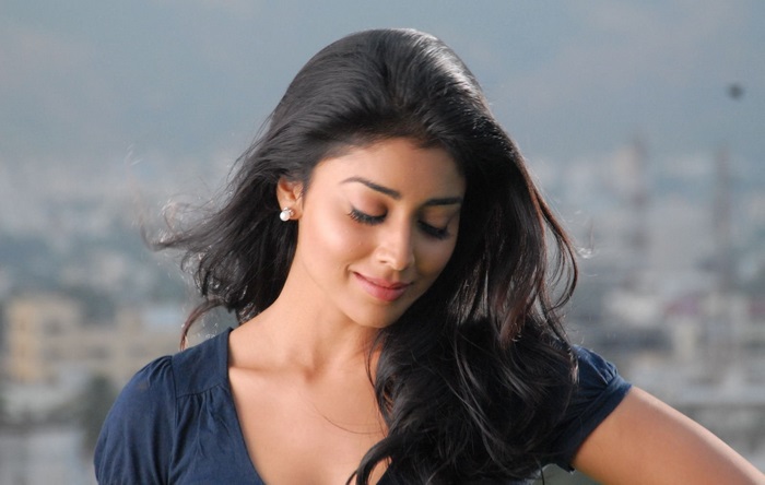 Shriya Saran looking down with wind blowing her hair
