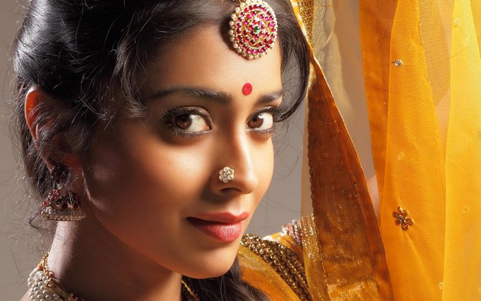 Shriya Saran wearing traditional Indian jewelry and attire