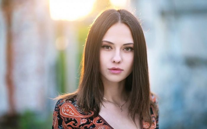 Woman in patterned dress with sunlight
