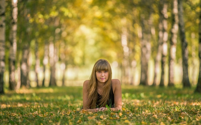 Young woman lying on grass in a park