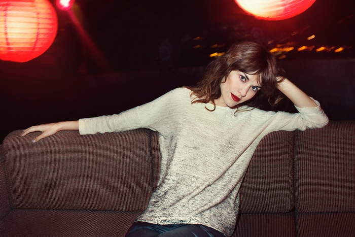 Alexa Chung sitting on a couch