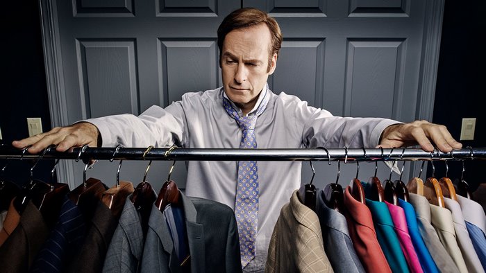 Bob Odenkirk in front of a closet full of suits
