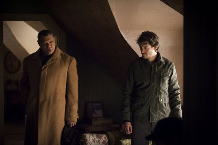 Laurence Fishburne and Hugh Dancy in a dimly lit room