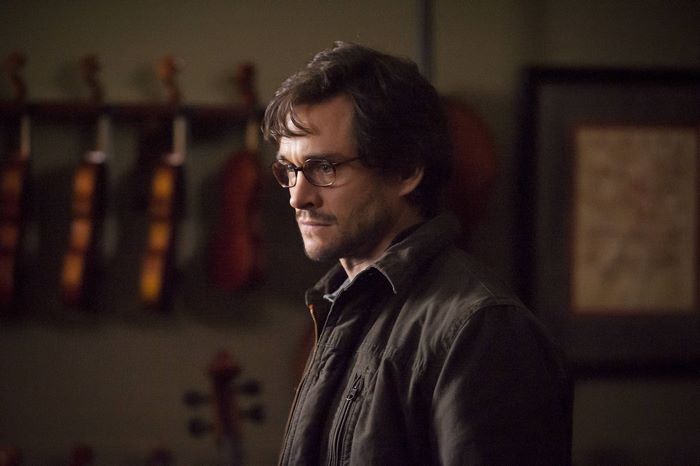 Hugh Dancy wearing glasses and a jacket