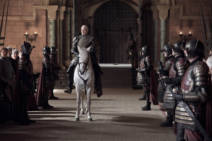 Charles Dance on horseback in a castle hall