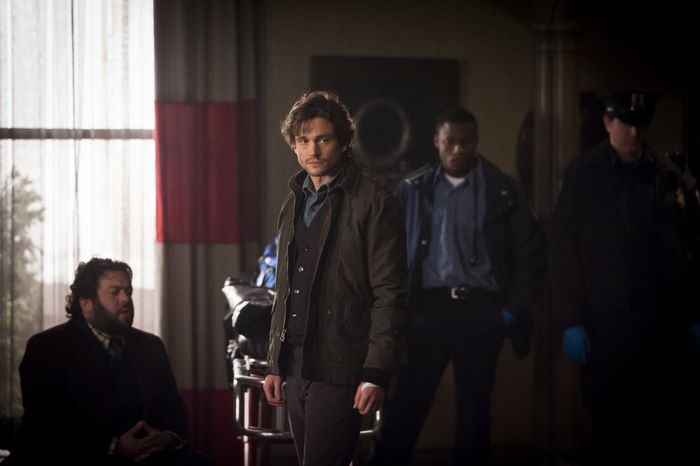 Hugh Dancy and others in a room