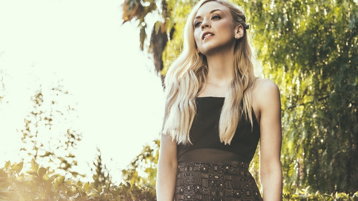 Emily Kinney in a Black Dress Outdoors