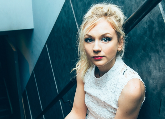 Emily Kinney sitting on stairs