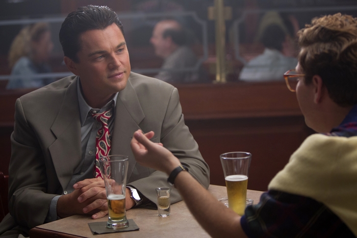 Leonardo DiCaprio and Jonah Hill at a table with drinks