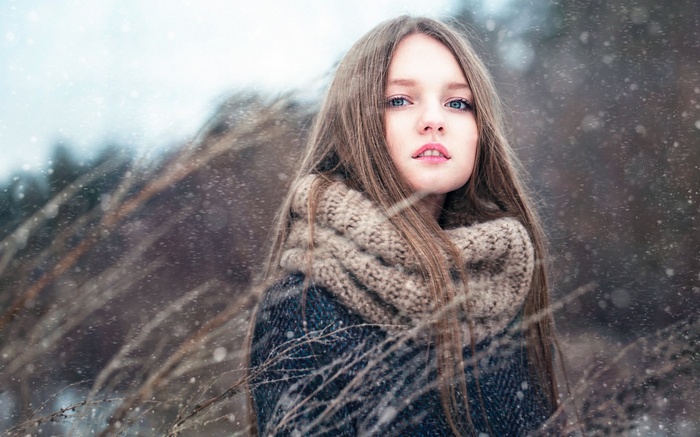 Woman in winter with snow falling