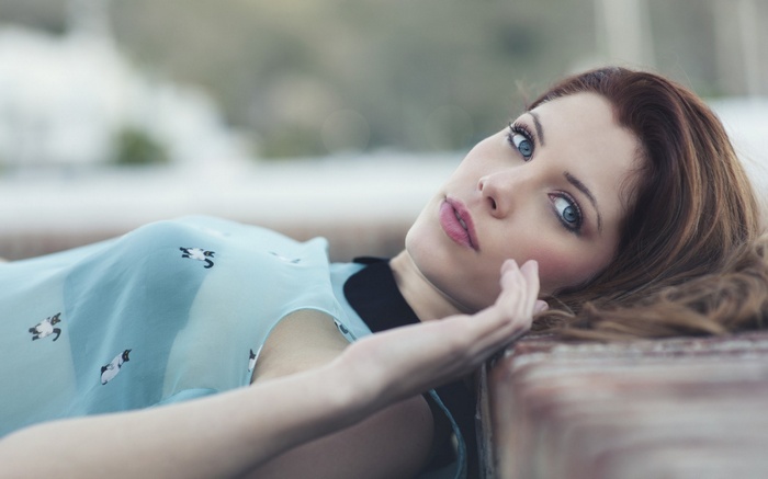 Woman with blue eyes lying down