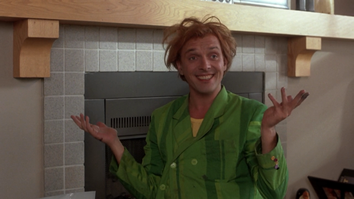 Rik Mayall in a green jacket