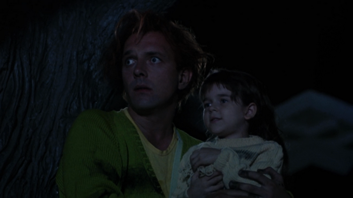 Rik Mayall holding a child