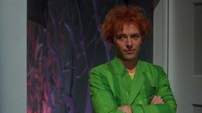 Rik Mayall in a green suit