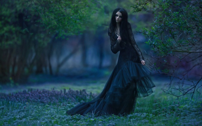 Woman in black dress in a forest