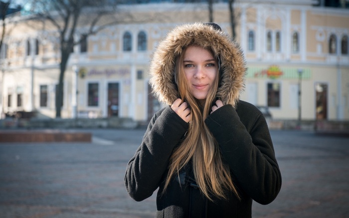 Young woman in a fur-hooded coat