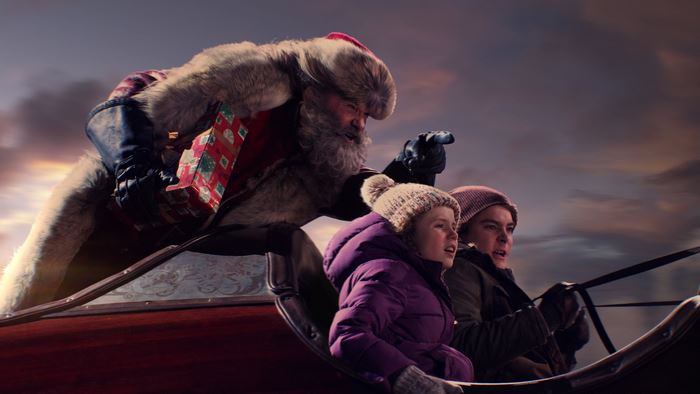 Kurt Russell as Santa Claus in a Sleigh with Children