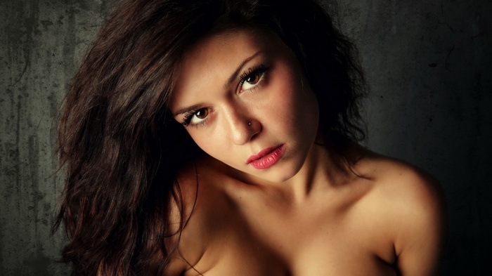 Woman with dark hair and bare shoulders