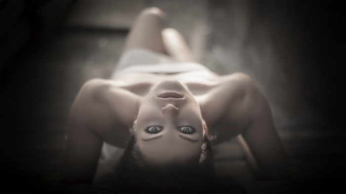 Woman lying down with eyes open