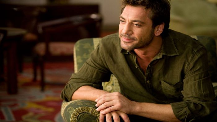Javier Bardem sitting in a chair