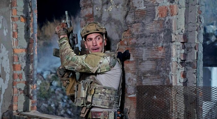 Jon Bernthal in tactical gear holding a rifle