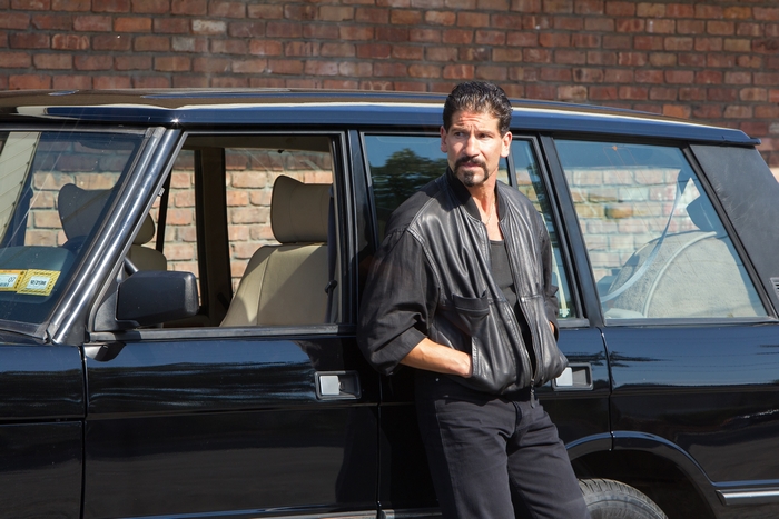Jon Bernthal leaning on a black Range Rover