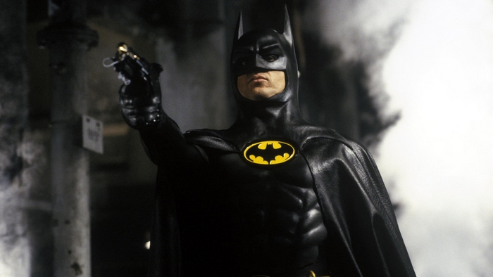 Michael Keaton as Batman holding a grappling gun