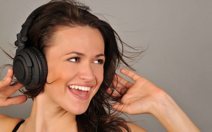 Woman wearing headphones and smiling