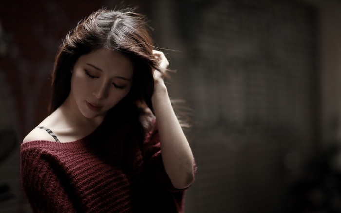 Woman with dark hair wearing a maroon sweater