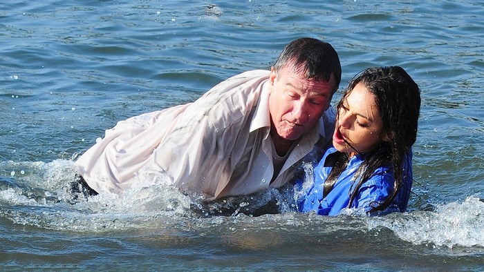 Robin Williams and woman in water