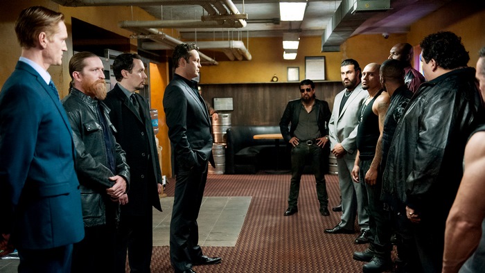 Vince Vaughn and men in a room