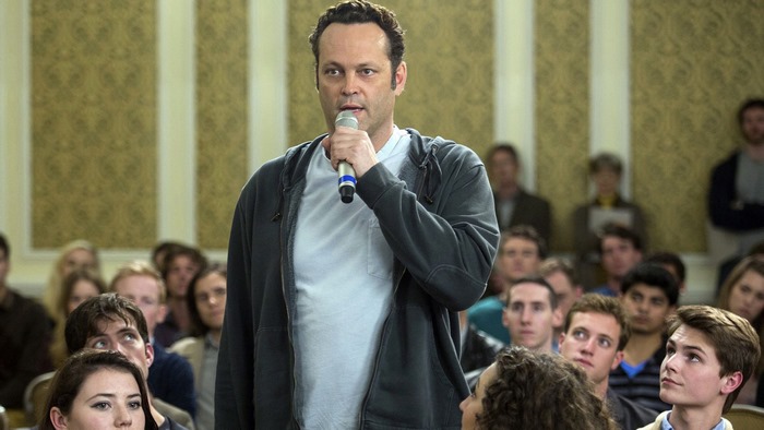 Vince Vaughn speaking into a microphone in front of an audience