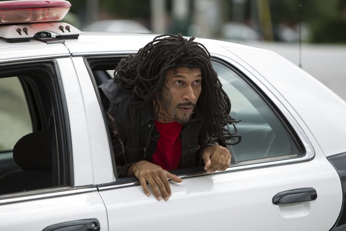 Damon Wayans Jr. in a police car