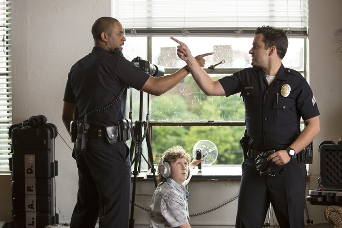 Damon Wayans Jr. and another man as police officers with a boy