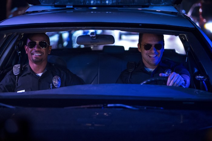 Damon Wayans Jr. and another man in a police car