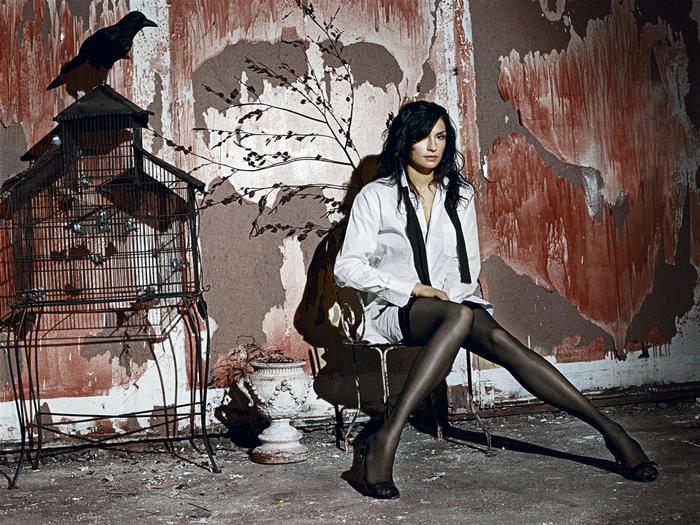Famke Janssen in a white shirt and stockings