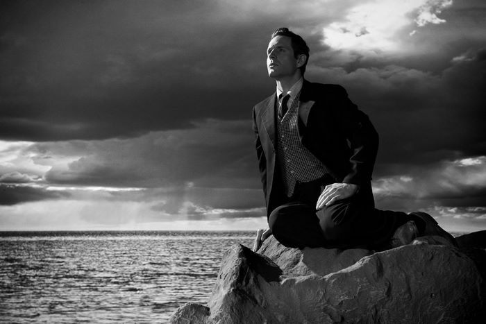 Glenn Howerton sitting on rocks by the sea